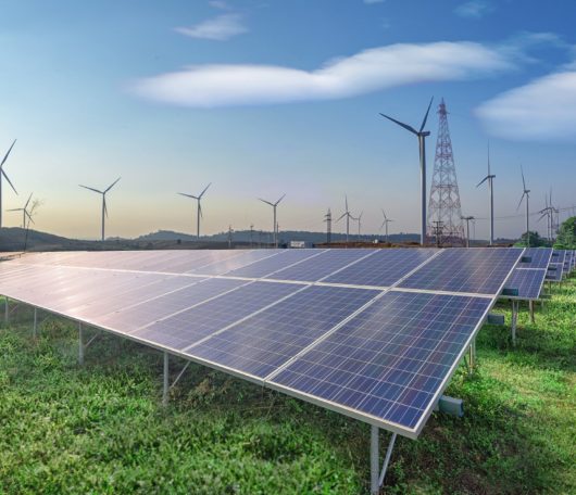 renewable-energy-solar-panels-wind-turbines-green-grass-blue-sky